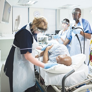 Nurse reassuring patient during colonoscopy